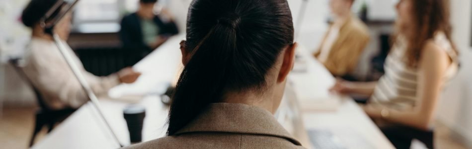 Diverse professionals collaborating in a modern office space, focused on teamwork and project management.